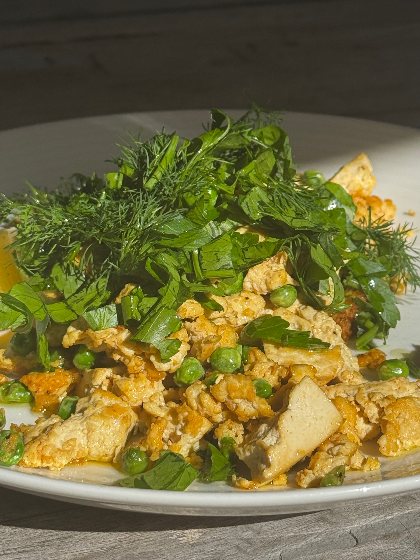 Eggs baked with fresh herbs and tomatoes in a pan, a high protein Mediterranean breakfast